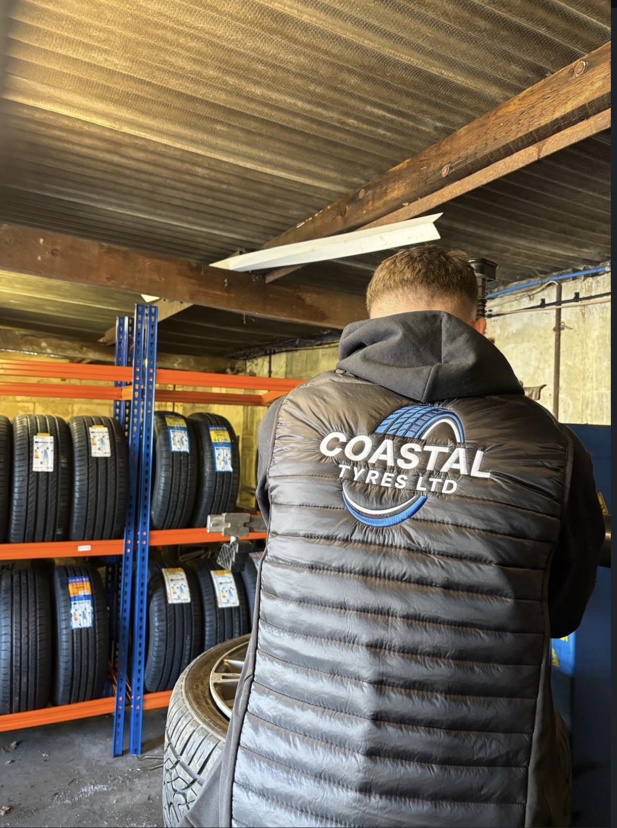 Coastal Tyres technician fitting a tyre in the Ringwood workshop